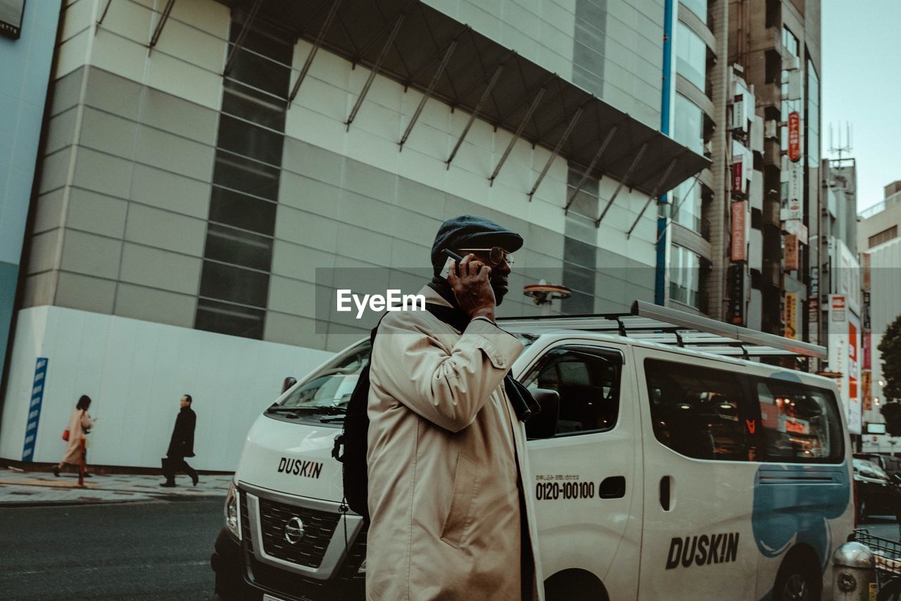 MAN STANDING IN CITY