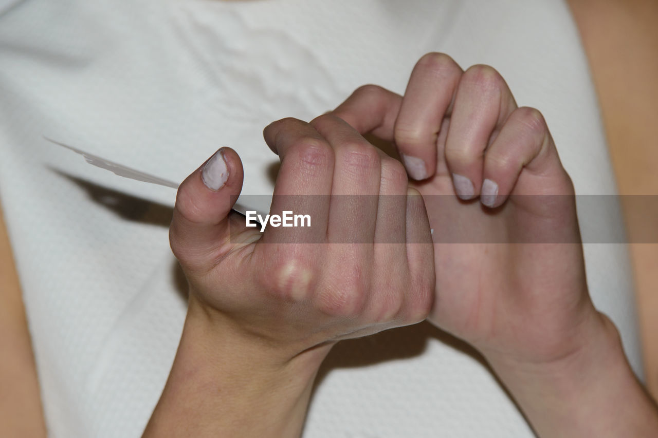 HIGH ANGLE VIEW OF PEOPLE HAND ON FINGER