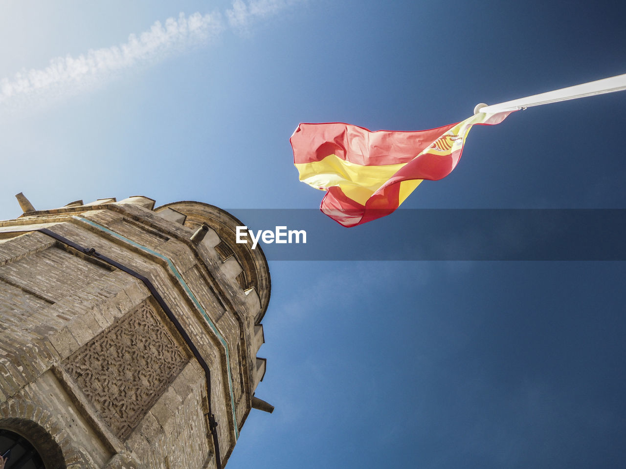 LOW ANGLE VIEW OF RED FLAG AGAINST BLUE SKY