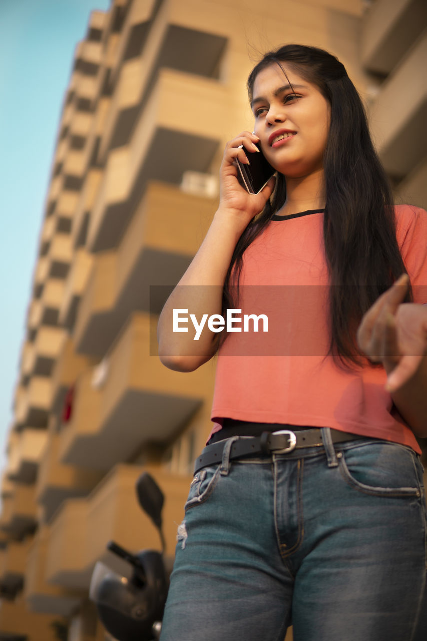 portrait of young woman talking on mobile phone