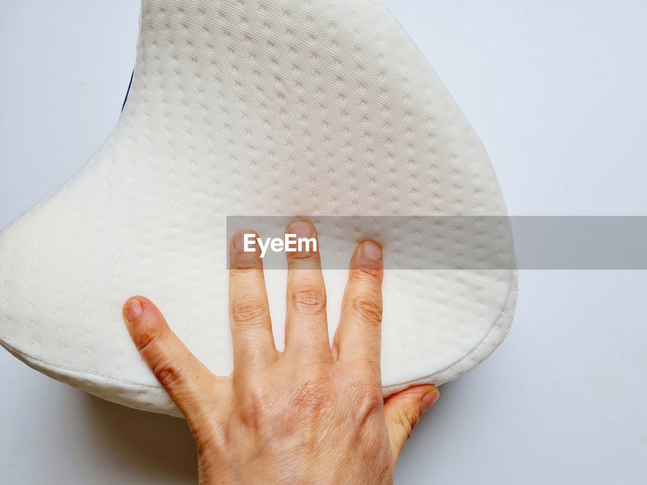 CLOSE-UP OF WOMAN HAND TOUCHING WHITE BACKGROUND