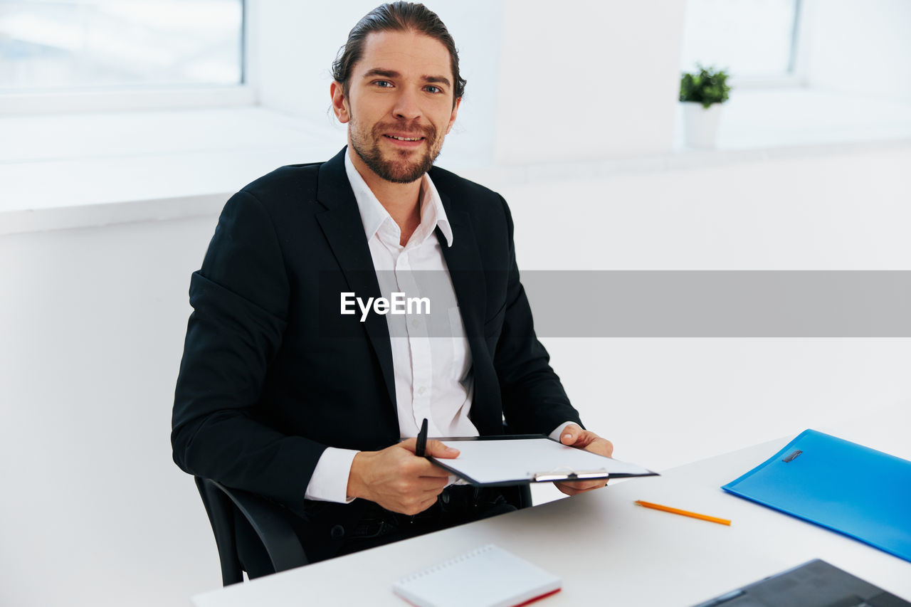 portrait of young man working on desk in office