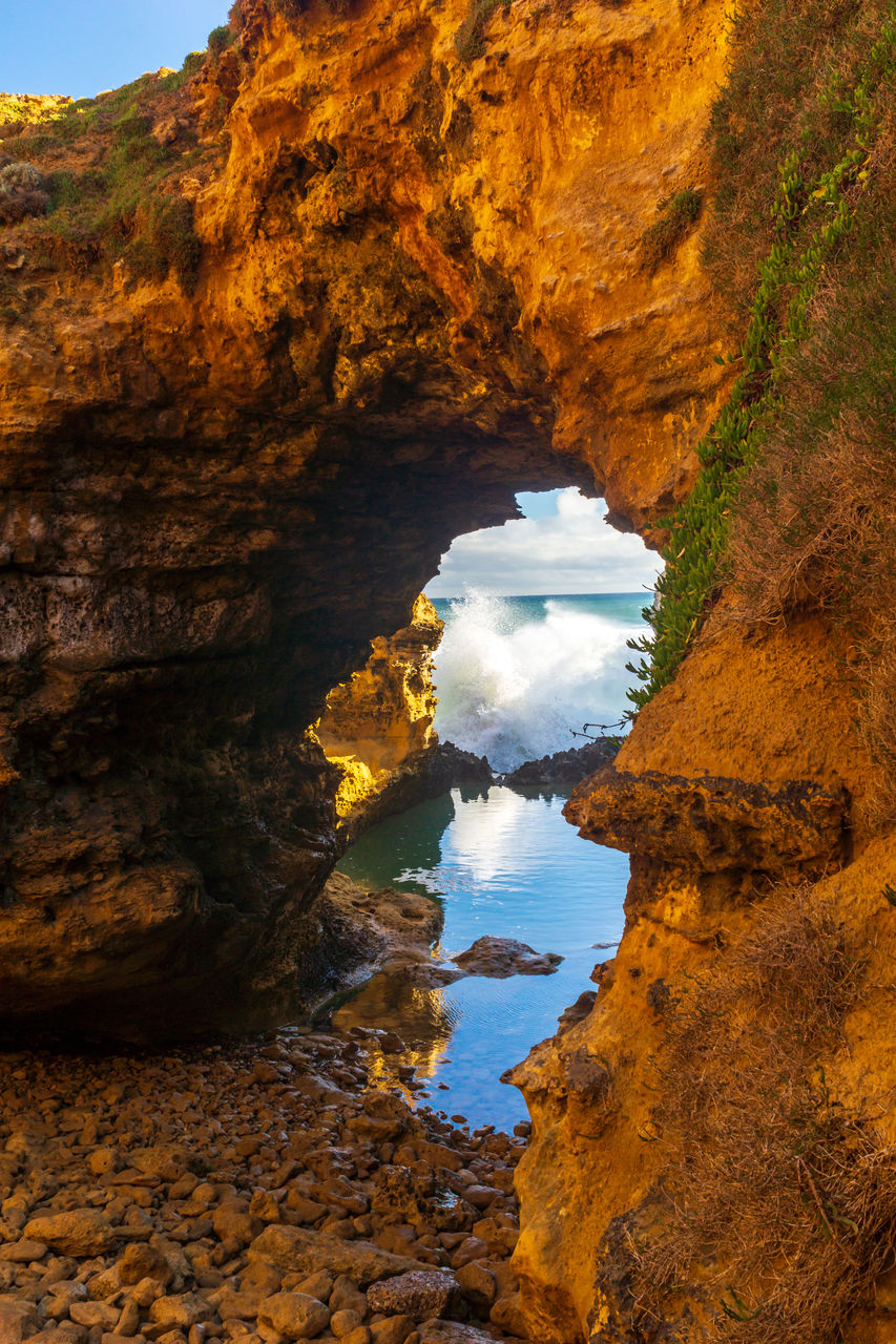 SCENIC VIEW OF SEA SEEN THROUGH ROCK FORMATION