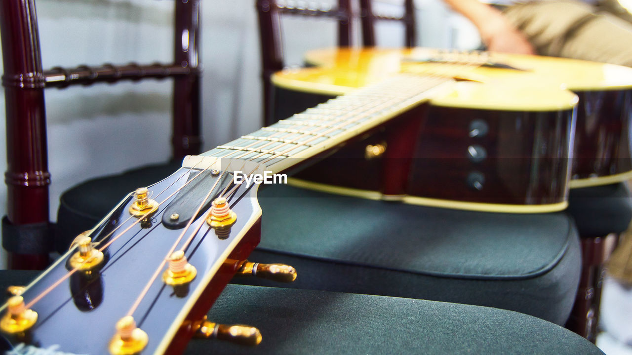 CLOSE-UP OF GUITAR ON CARPET