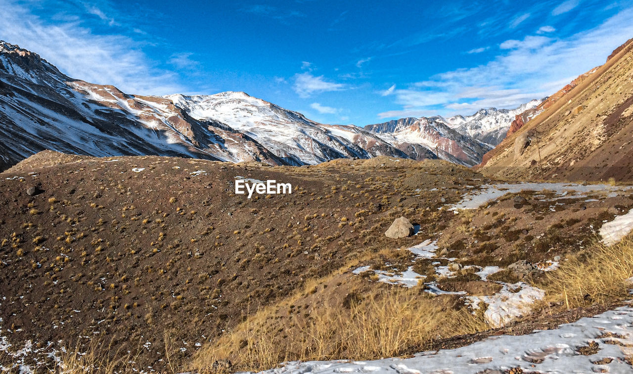 SCENIC VIEW OF MOUNTAINS AGAINST SKY DURING WINTER