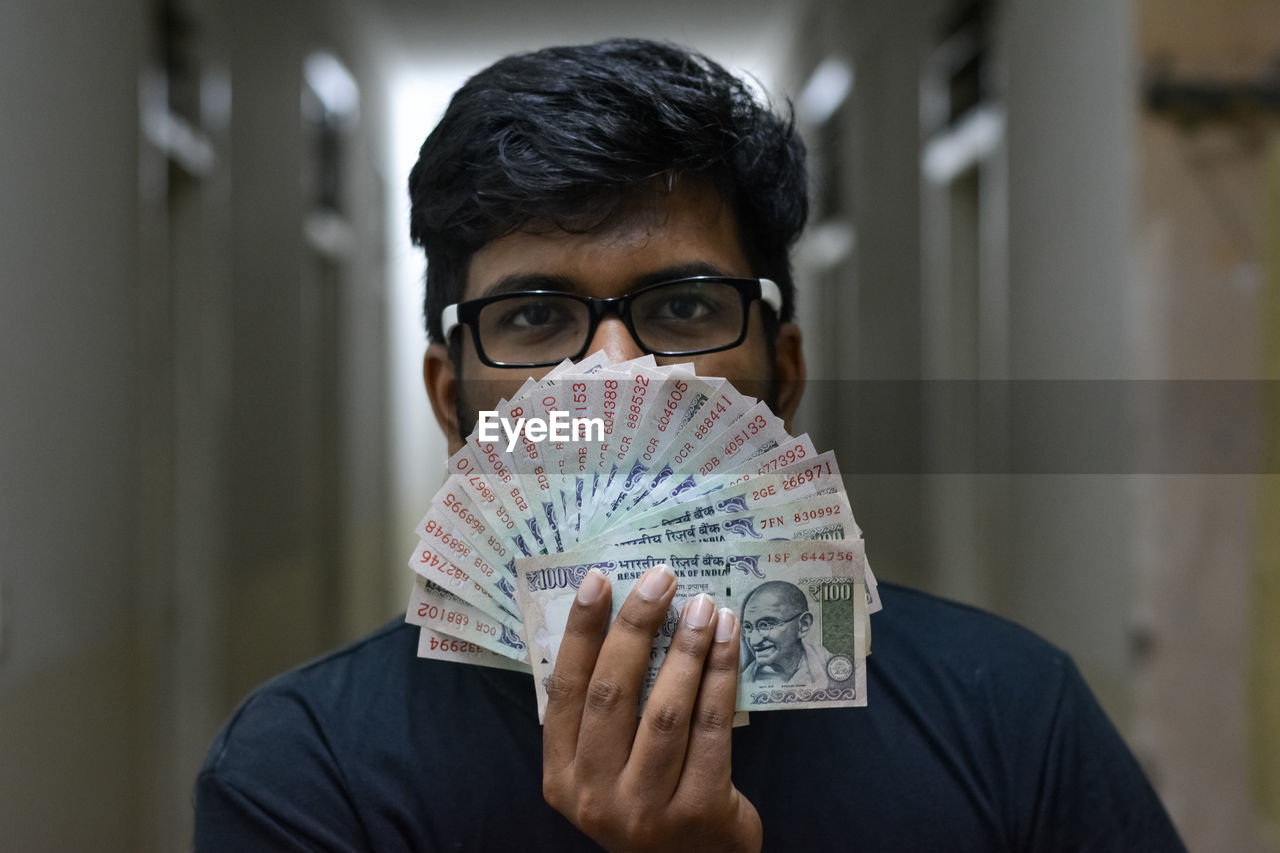 Portrait of man holding currency