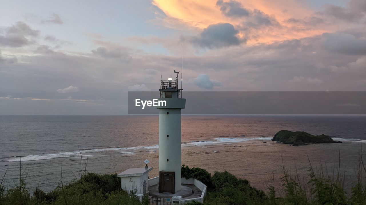 Lighthouse against the ocean in sunset