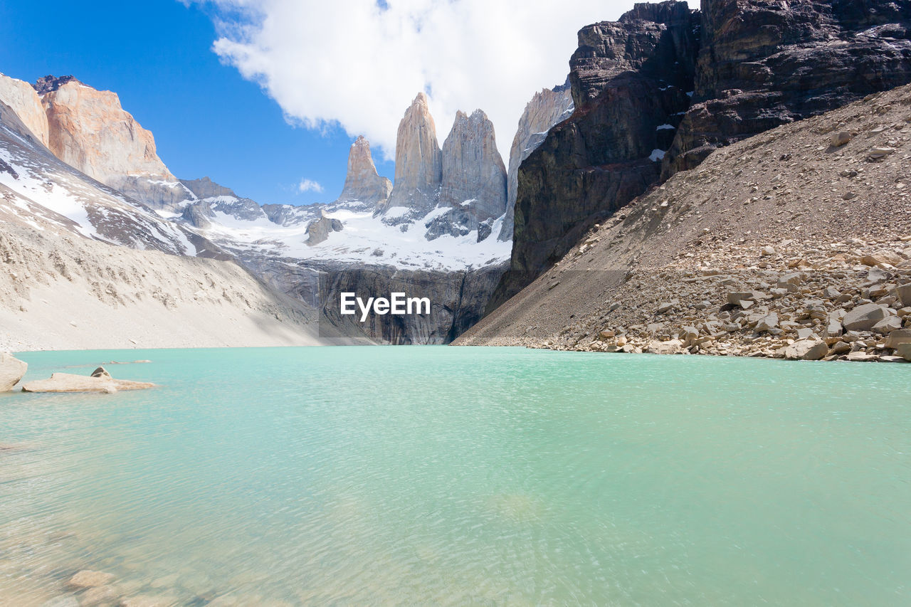 mountain, water, scenics - nature, environment, landscape, beauty in nature, mountain range, nature, sky, snow, land, cold temperature, travel destinations, travel, sea, turquoise colored, ice, cloud, blue, winter, tranquil scene, glacier, tourism, mountain peak, tranquility, glacial landform, rock, vacation, leisure activity, trip, outdoors, snowcapped mountain, holiday, day, adventure, lagoon, no people, idyllic, beach, activity, sunny, sunlight, non-urban scene, panoramic, extreme terrain, reflection, summer, wilderness