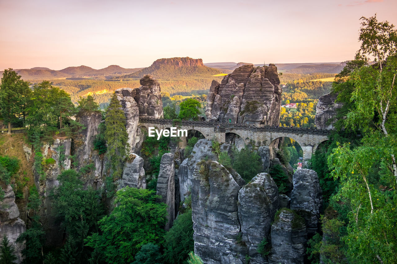 Panoramic view of bridge and rock formations at sunset