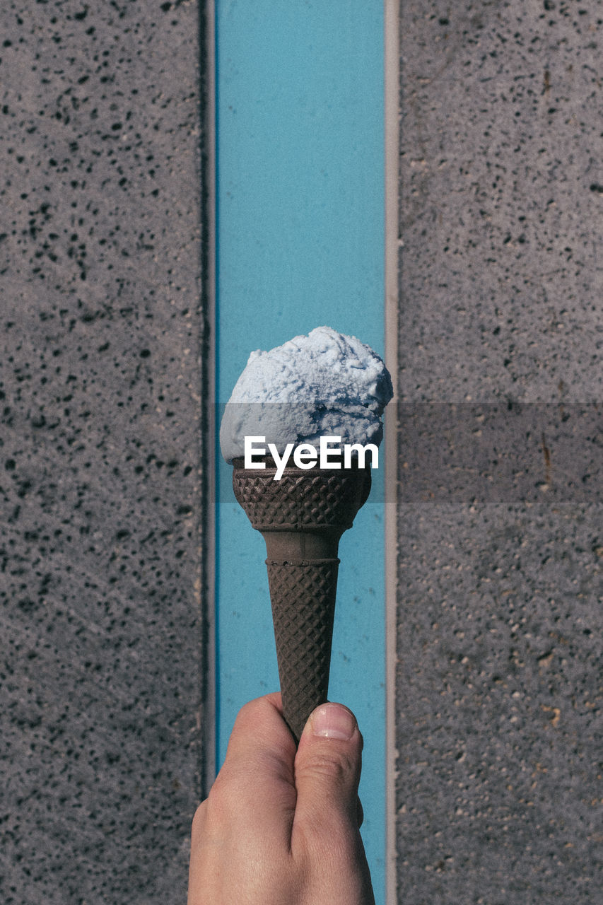 Blue colored ice cream cone with blue black back