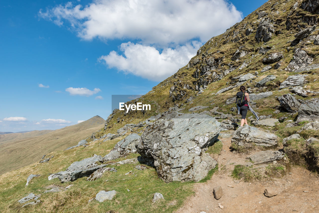 Young female hiker between rocks on ben lawers hike