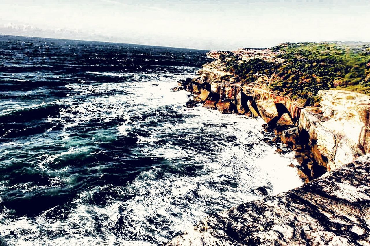 SCENIC VIEW OF SEA WITH ROCKS IN BACKGROUND