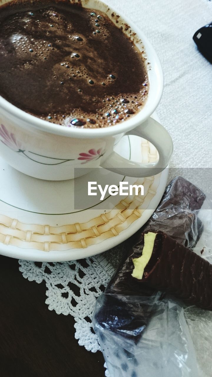 CLOSE-UP OF COFFEE CUP ON TABLE