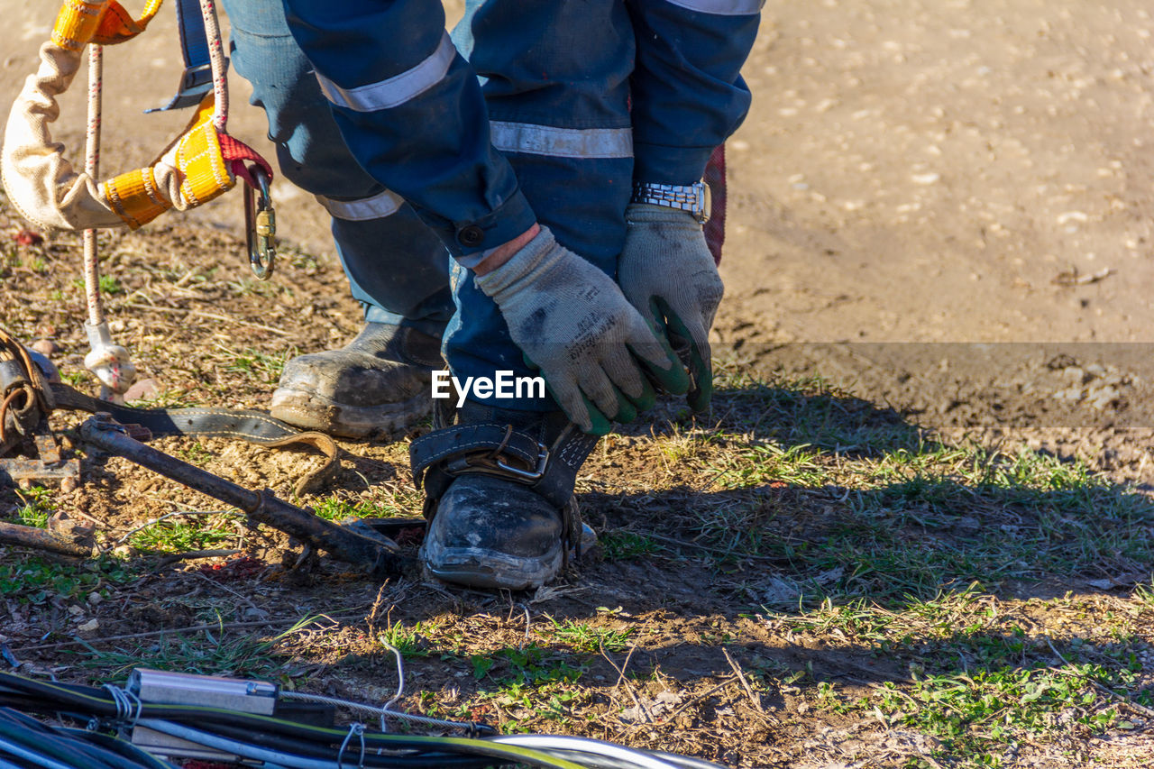 LOW SECTION OF MAN WORKING ON GROUND