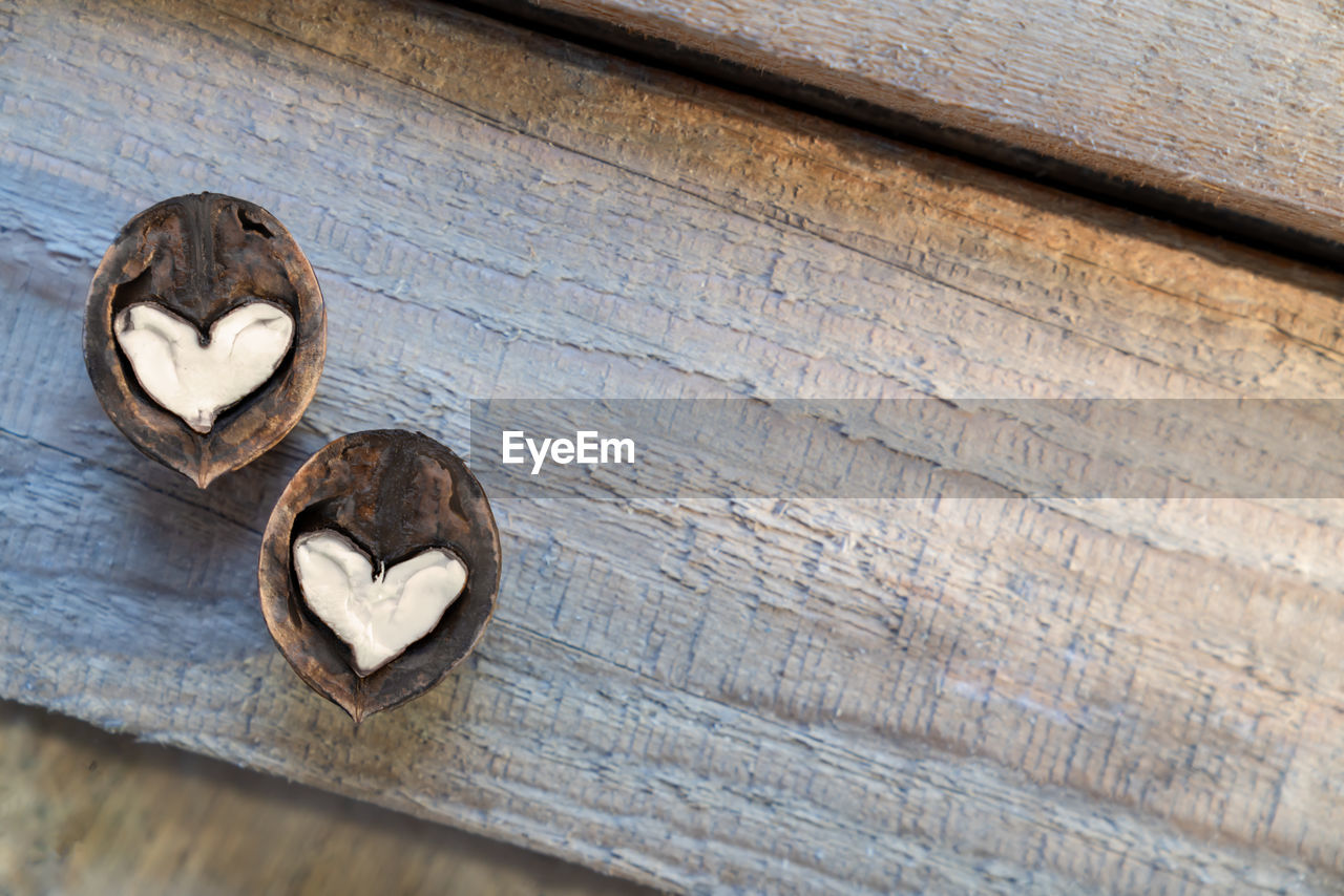 wood, no people, close-up, table, still life, heart shape, indoors, high angle view, love, positive emotion, brown, day, textured, food and drink, leaf