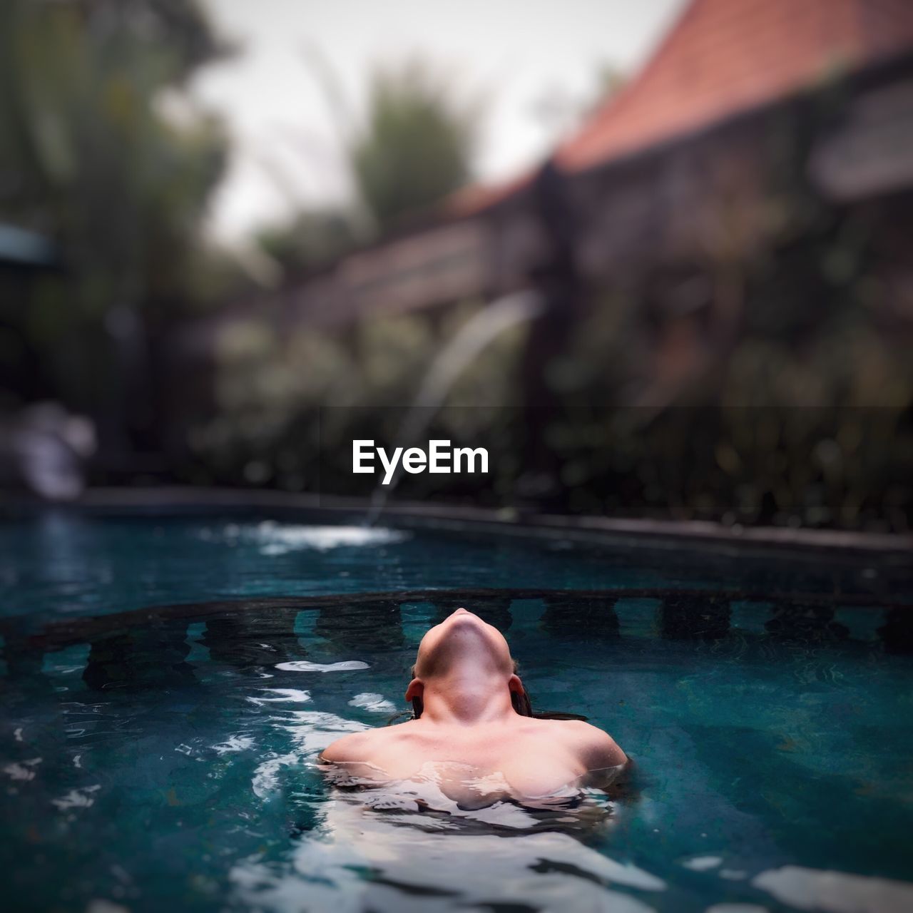 Seductive woman swimming in pool