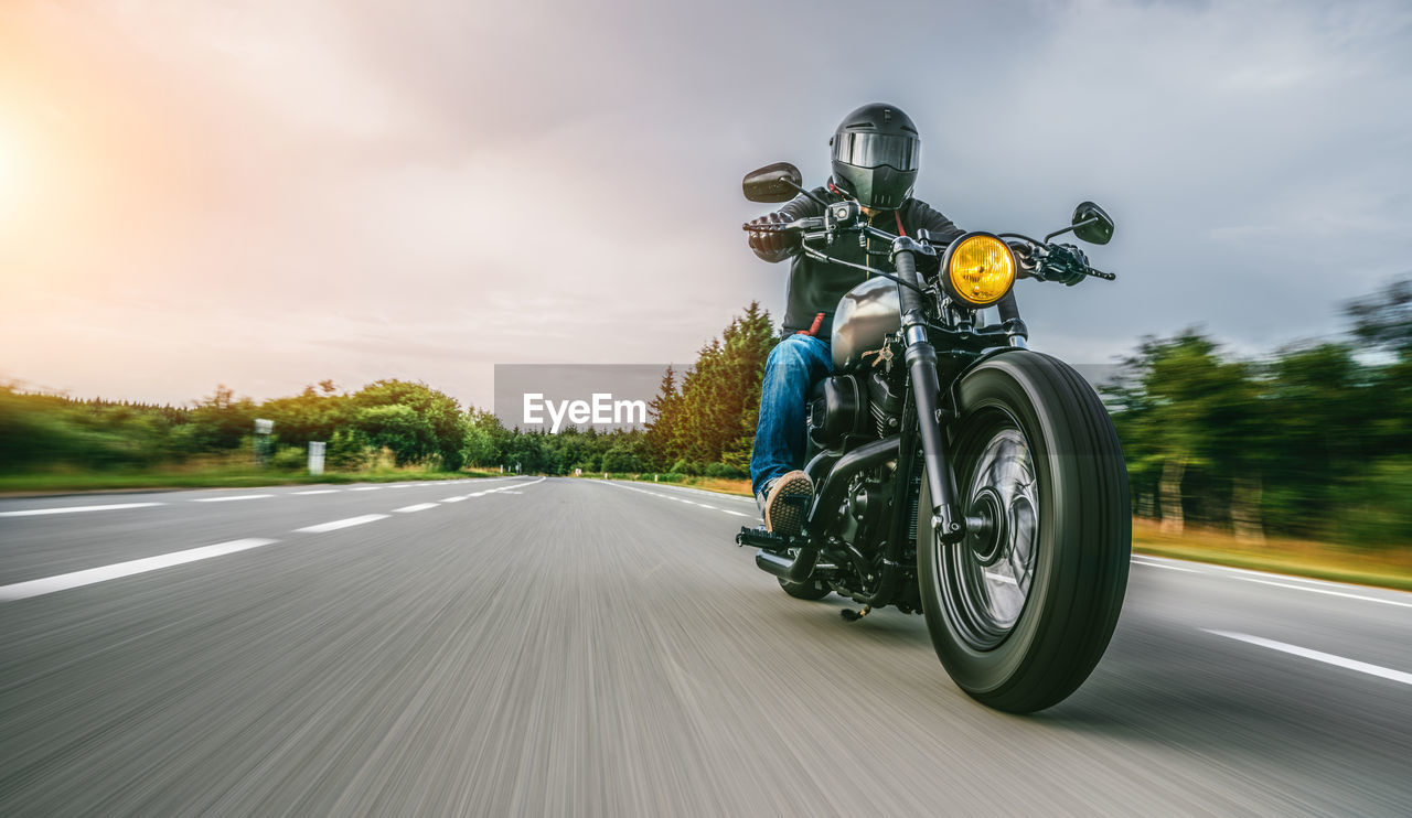 Man riding motorcycle on road