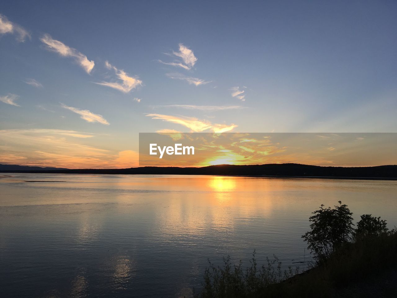 Scenic view of lake against sky during sunset