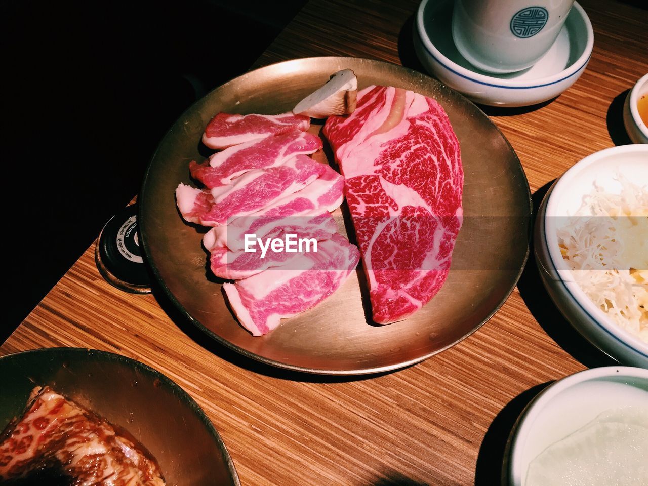 High angle view of raw meat on wooden table