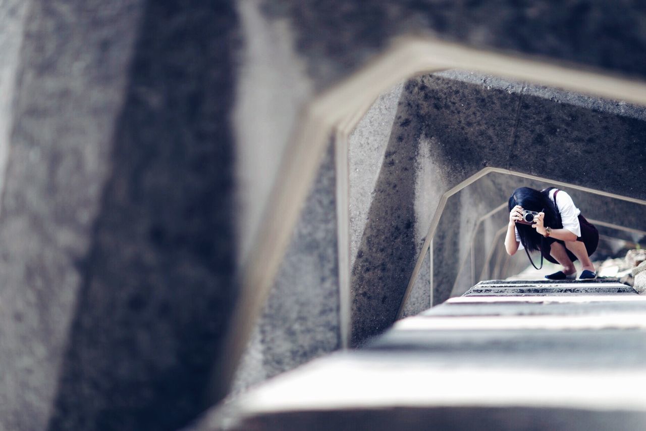 Woman photographing architectural feature