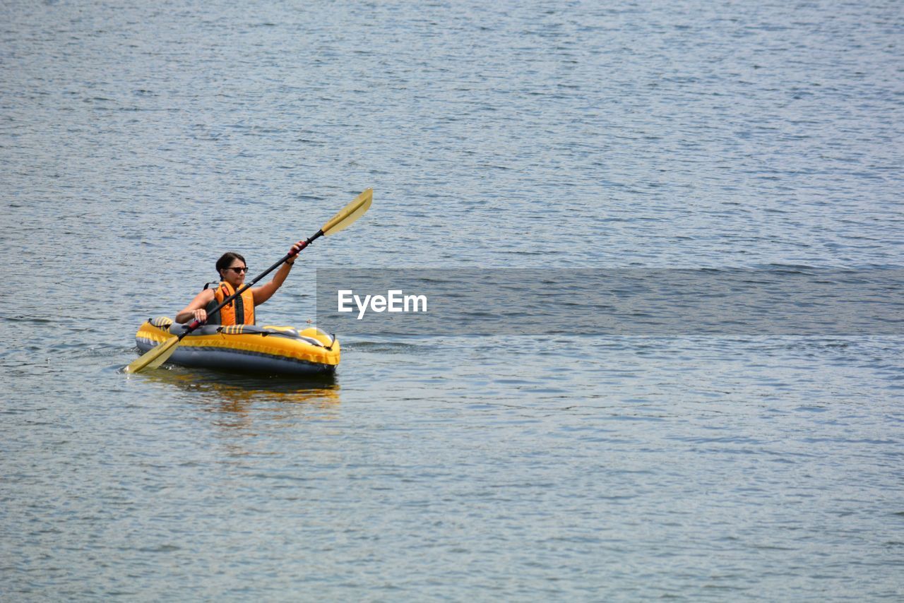 Woman in kayak on sea