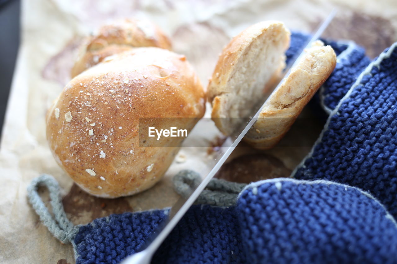 High angle view of bread buns being cut 