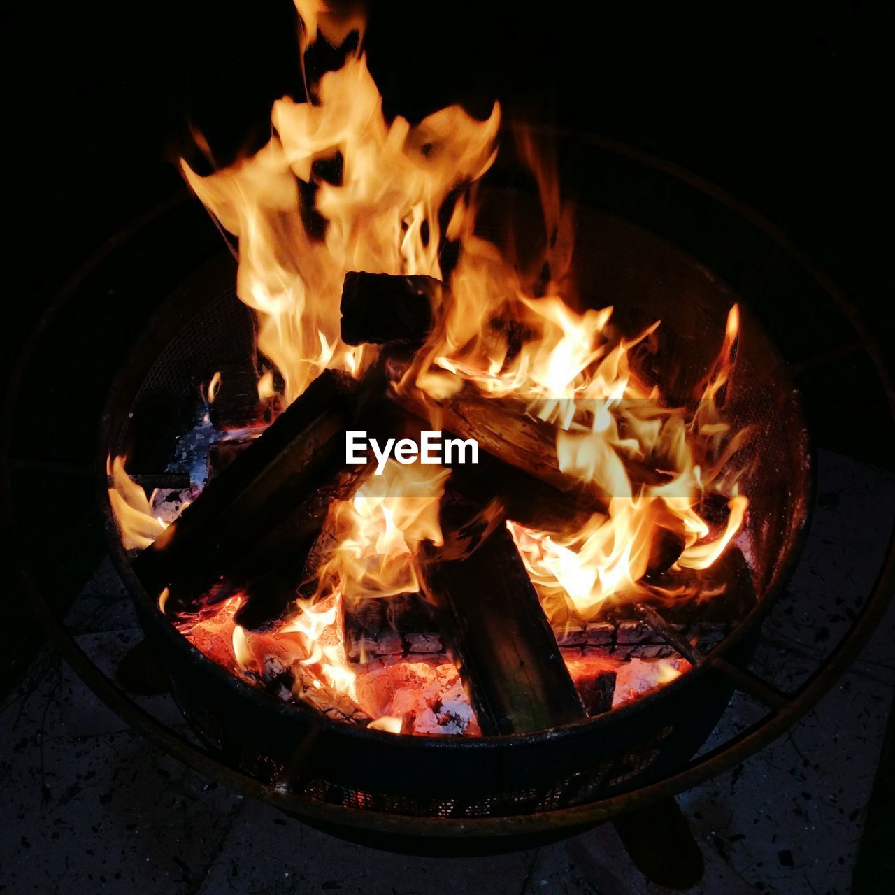 Close-up of lit fire pit at night