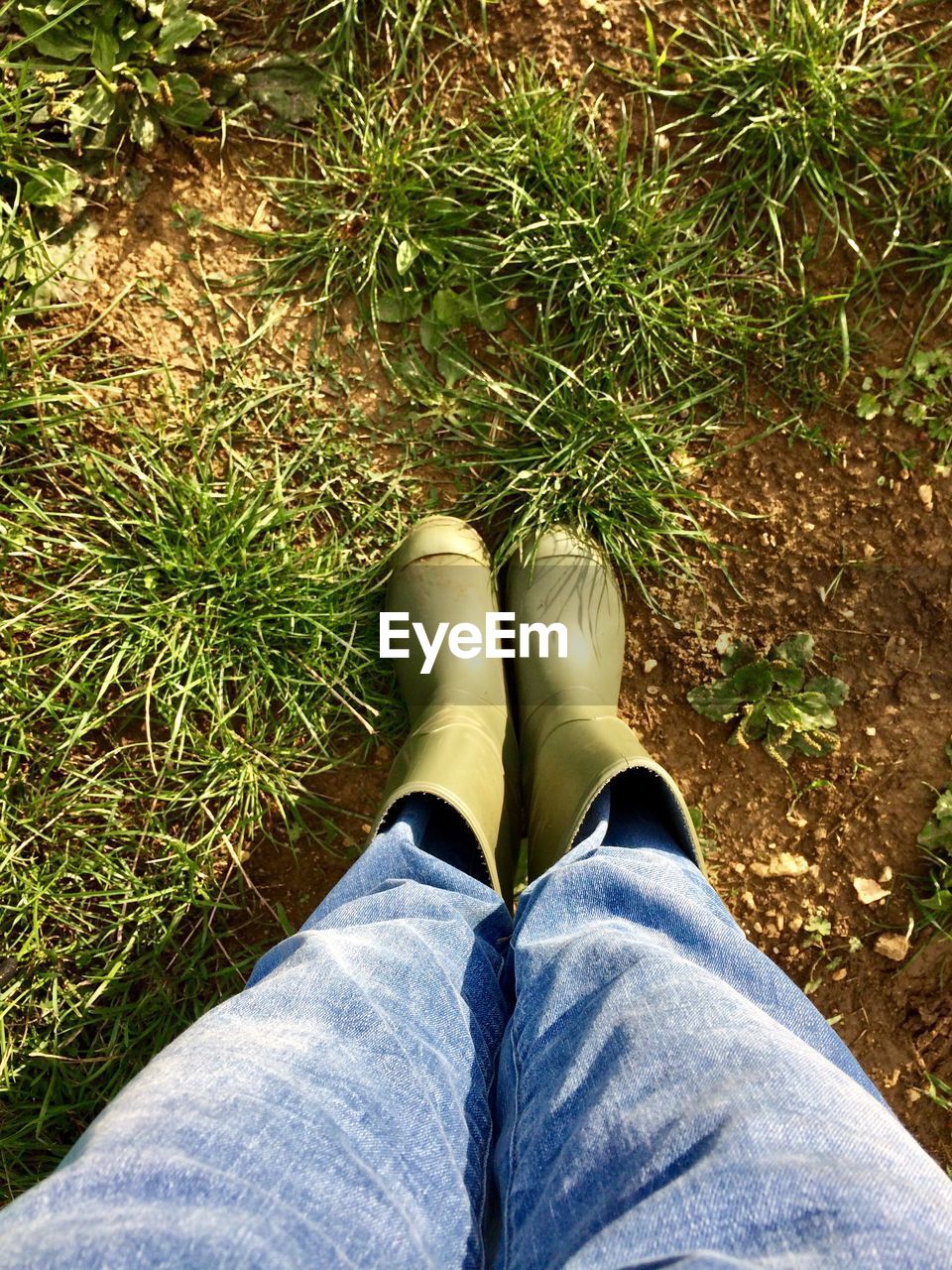 LOW SECTION OF PERSON STANDING ON GROUND