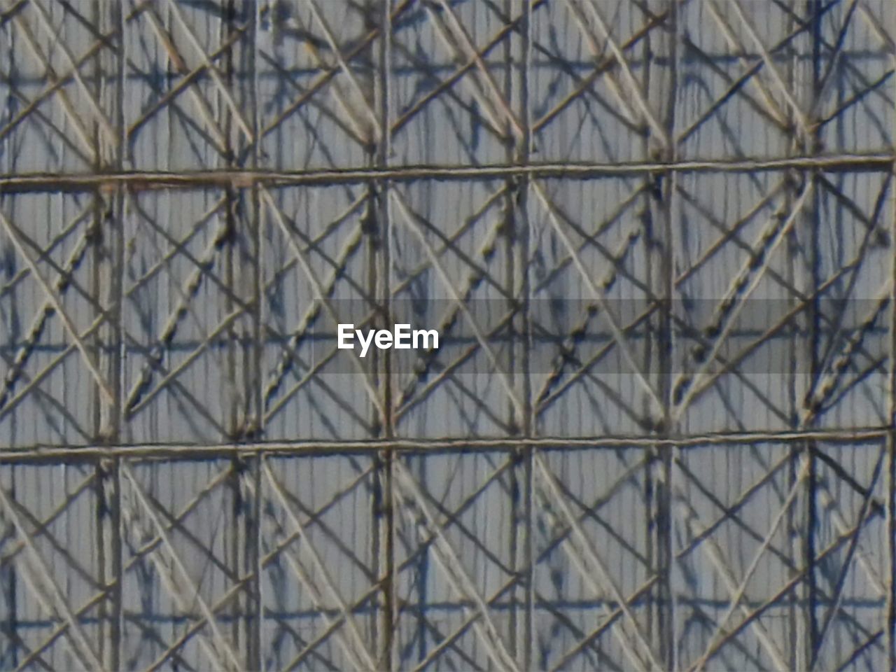 FULL FRAME SHOT OF CHAINLINK FENCE AGAINST SKY