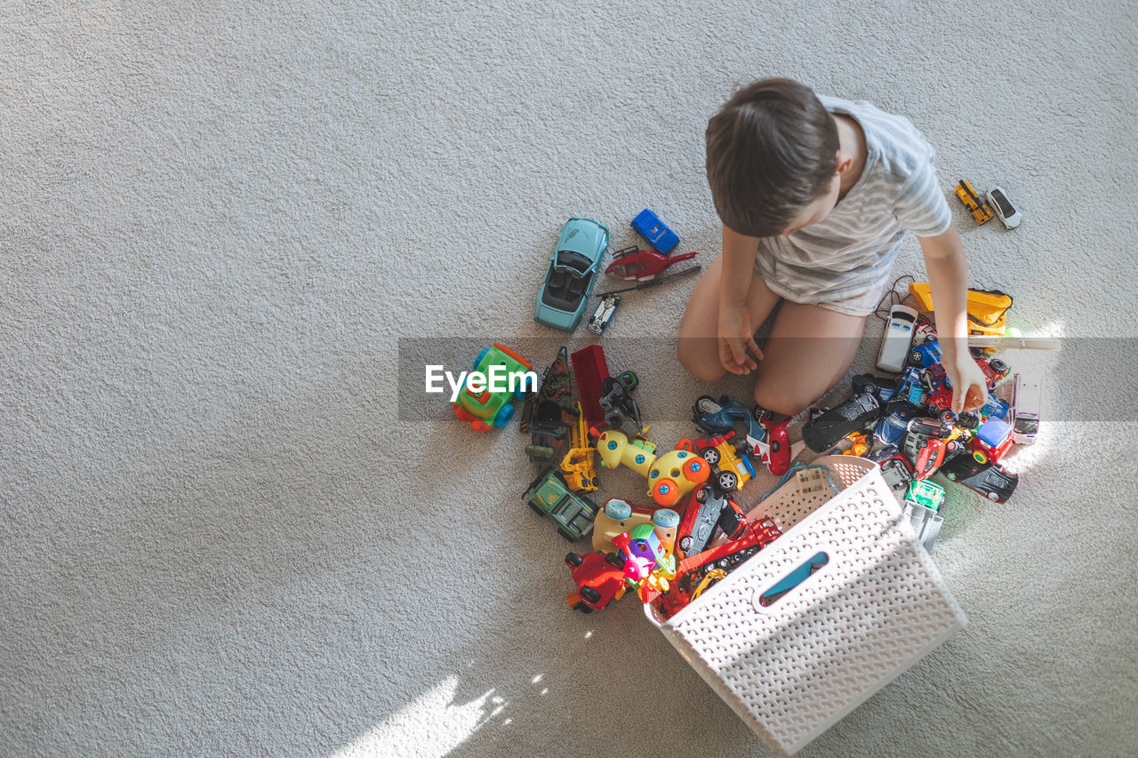 high angle view of boy playing with toy on street