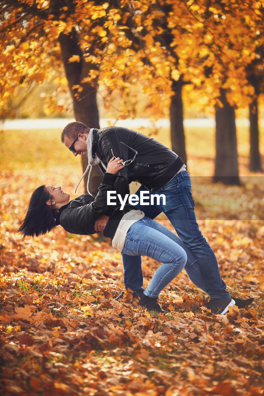 Couple dancing on field during autumn