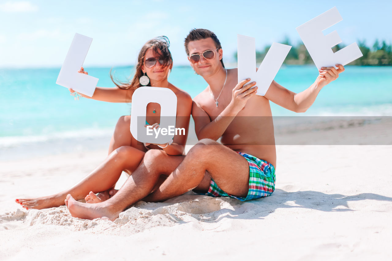 WOMAN SITTING ON BEACH