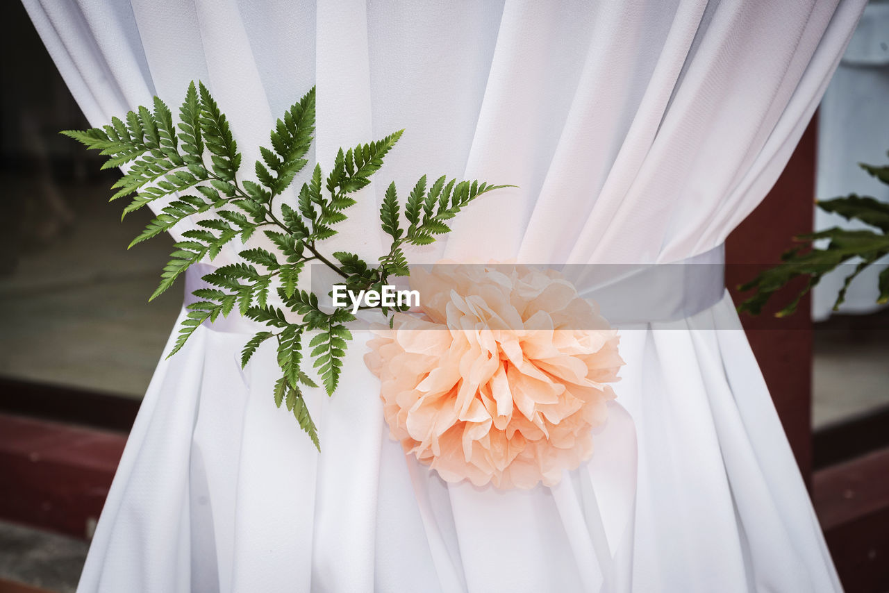 midsection of bride holding bouquet