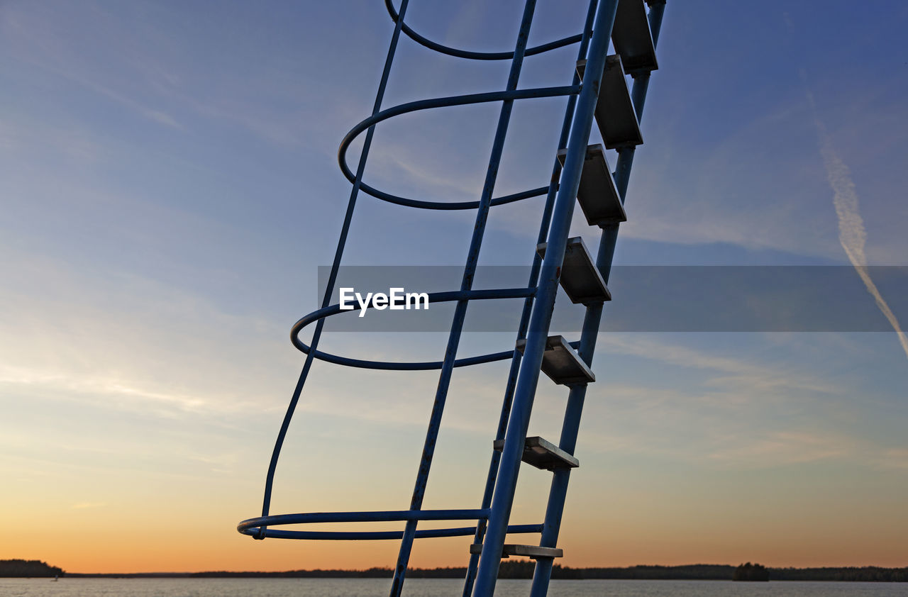 Ladder to jumping tower in sunset