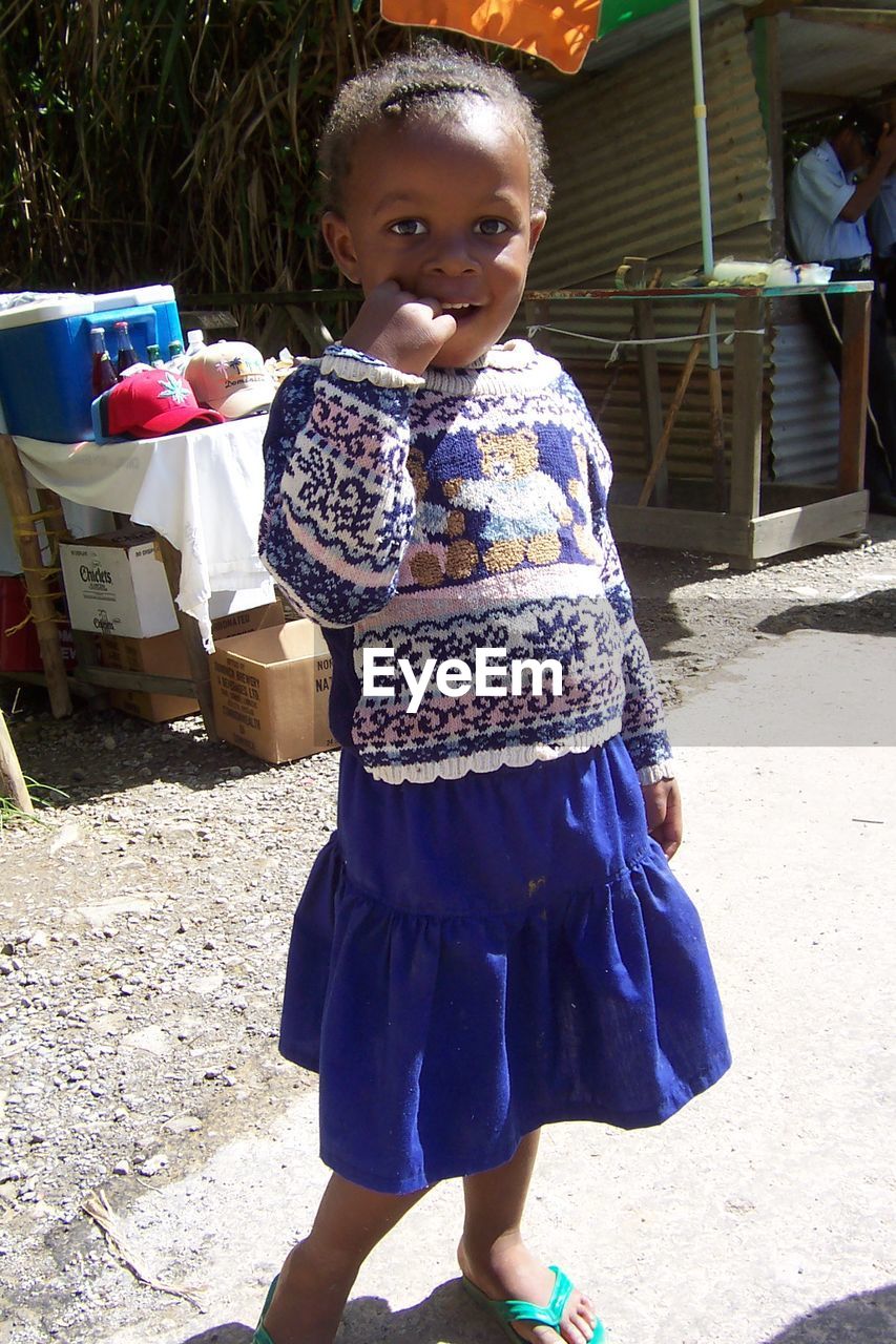 PORTRAIT OF CUTE GIRL STANDING ON FLOOR