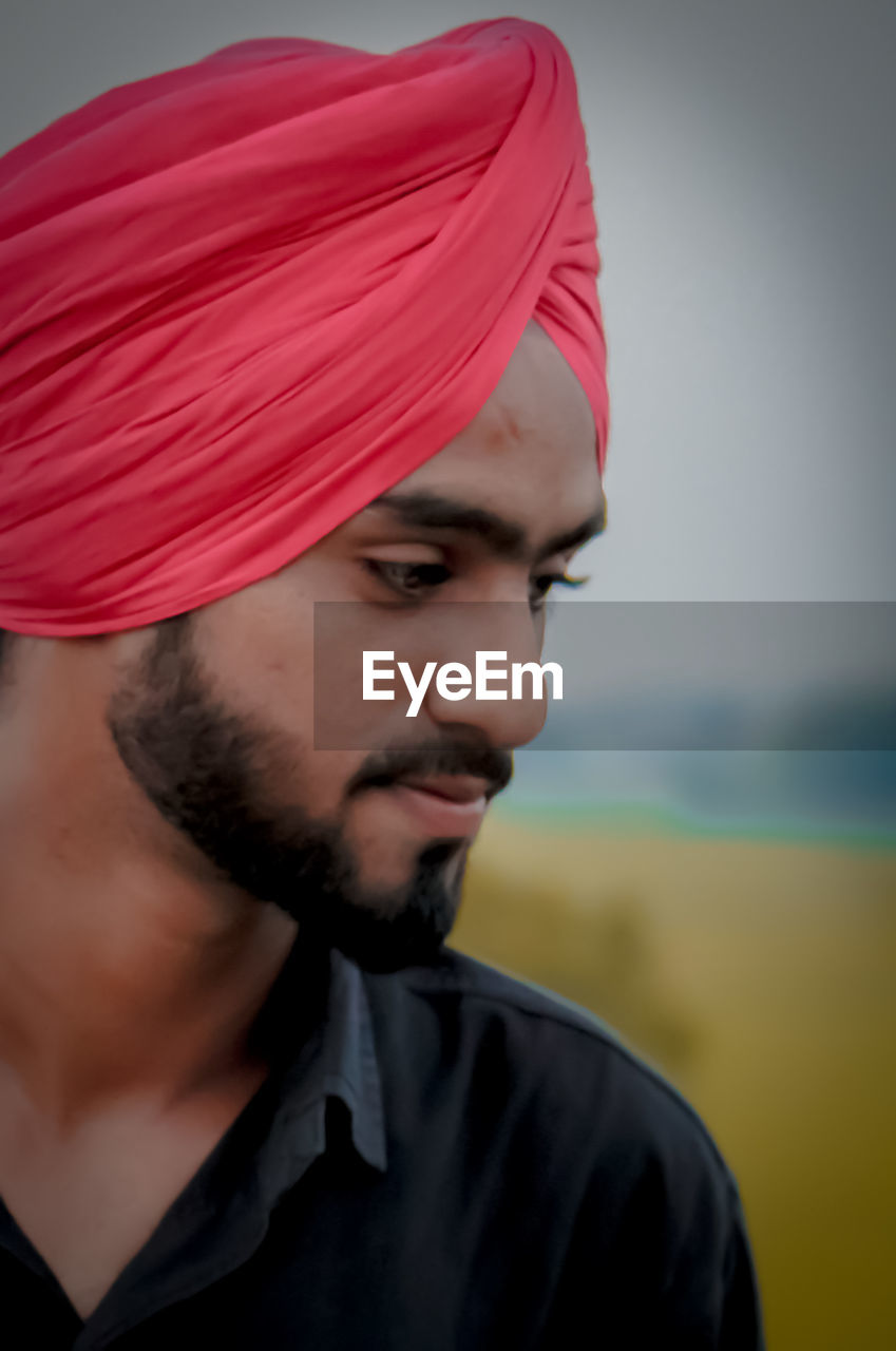 Close-up of man wearing turban standing outdoors