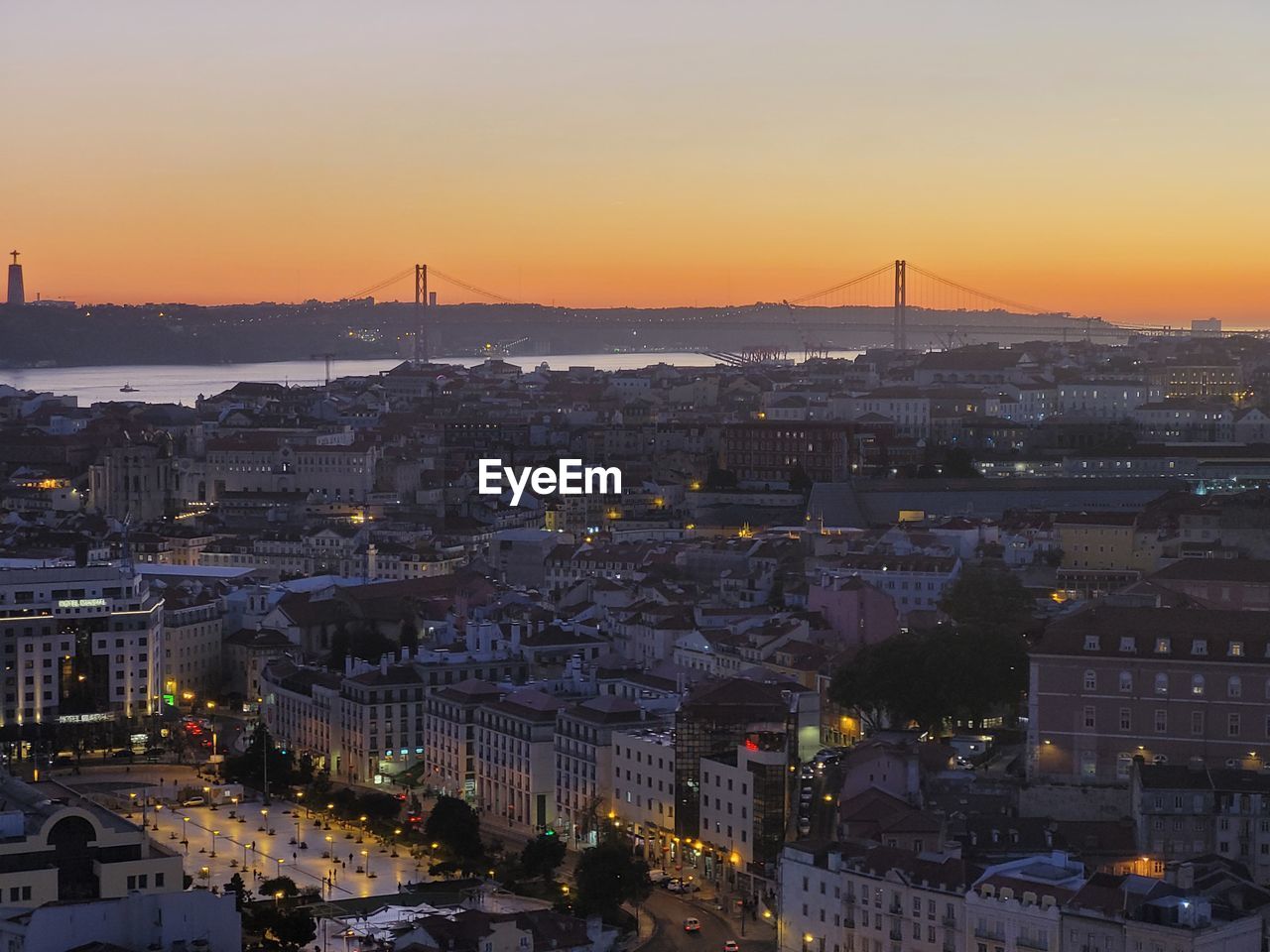 High angle view of illuminated buildings against sky during sunset in lisbon. 