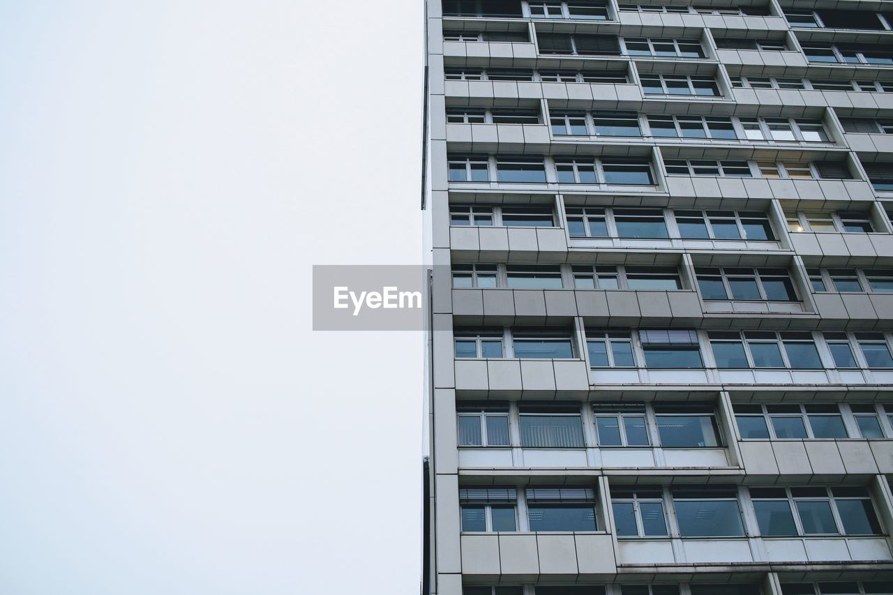 LOW ANGLE VIEW OF BUILDINGS IN CITY AGAINST CLEAR SKY