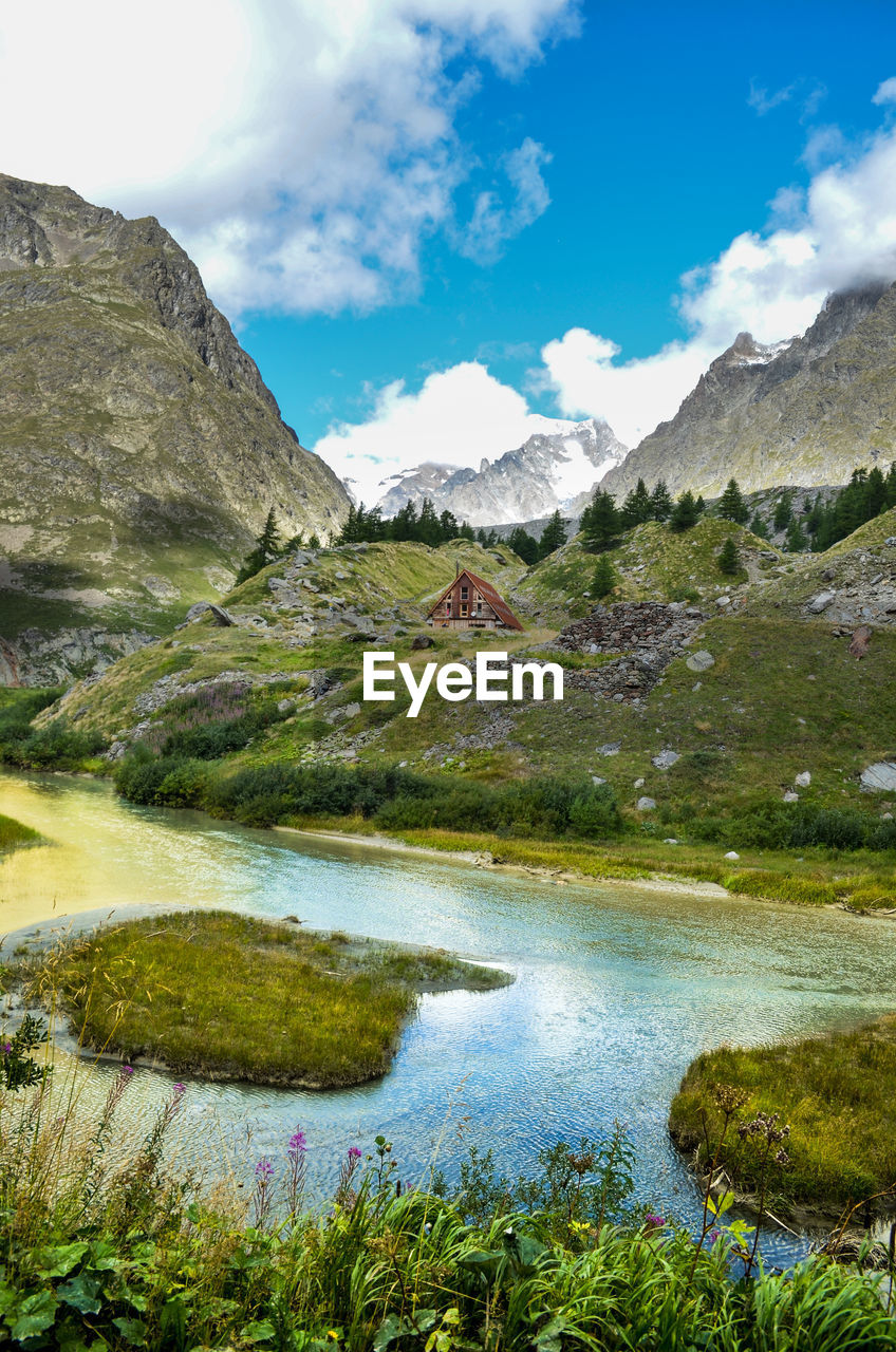 Scenic view of lake and mountains against sky