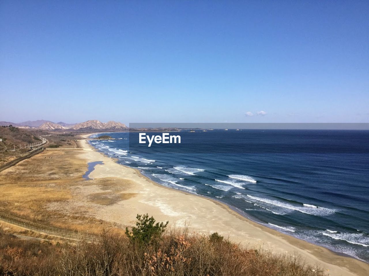 Scenic view of sea against clear blue sky