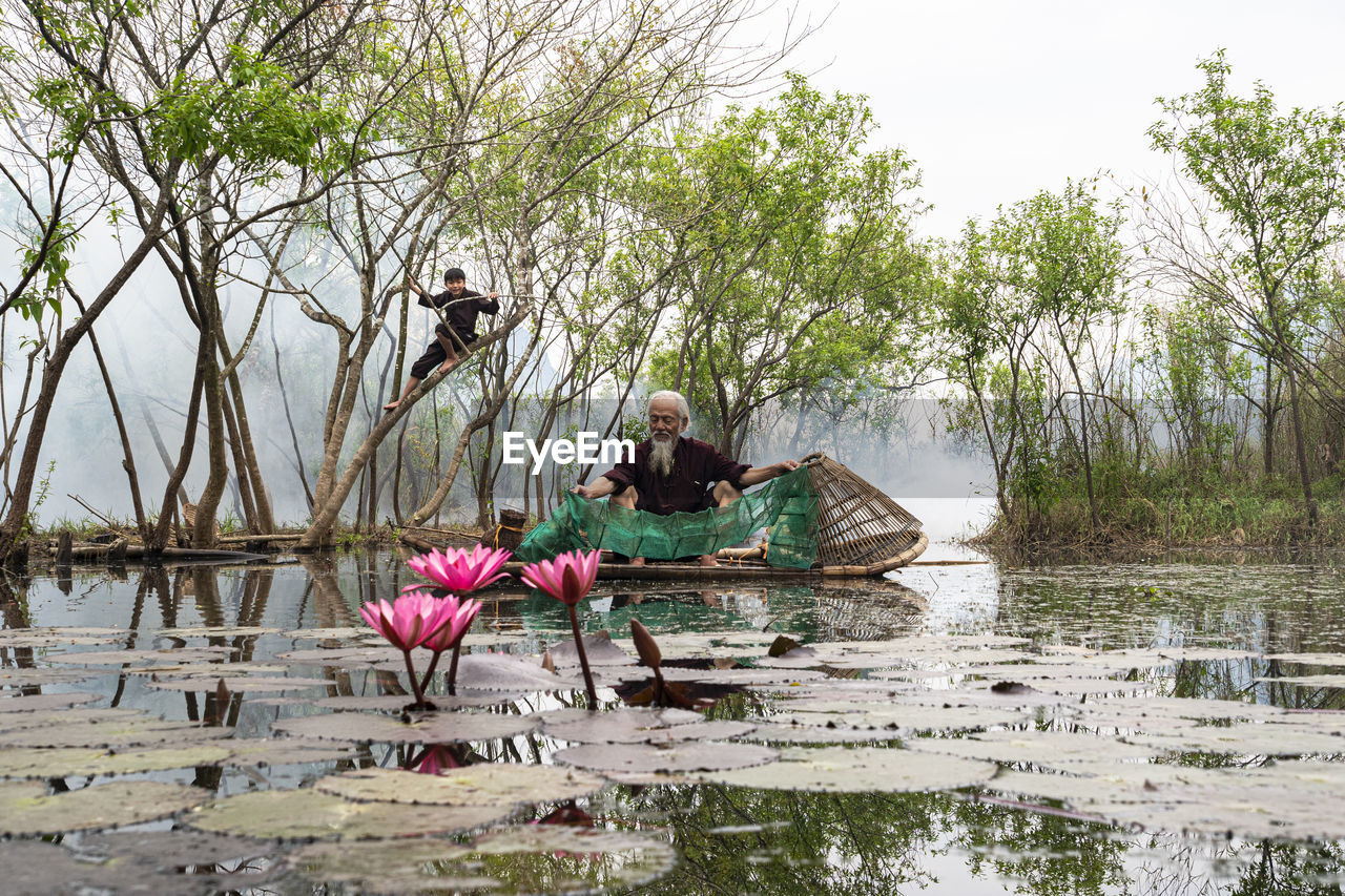 Senior man fishing in pond