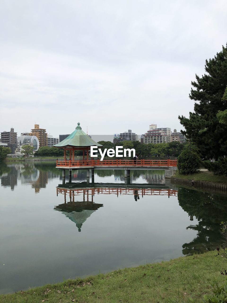 Reflection of building in lake against sky