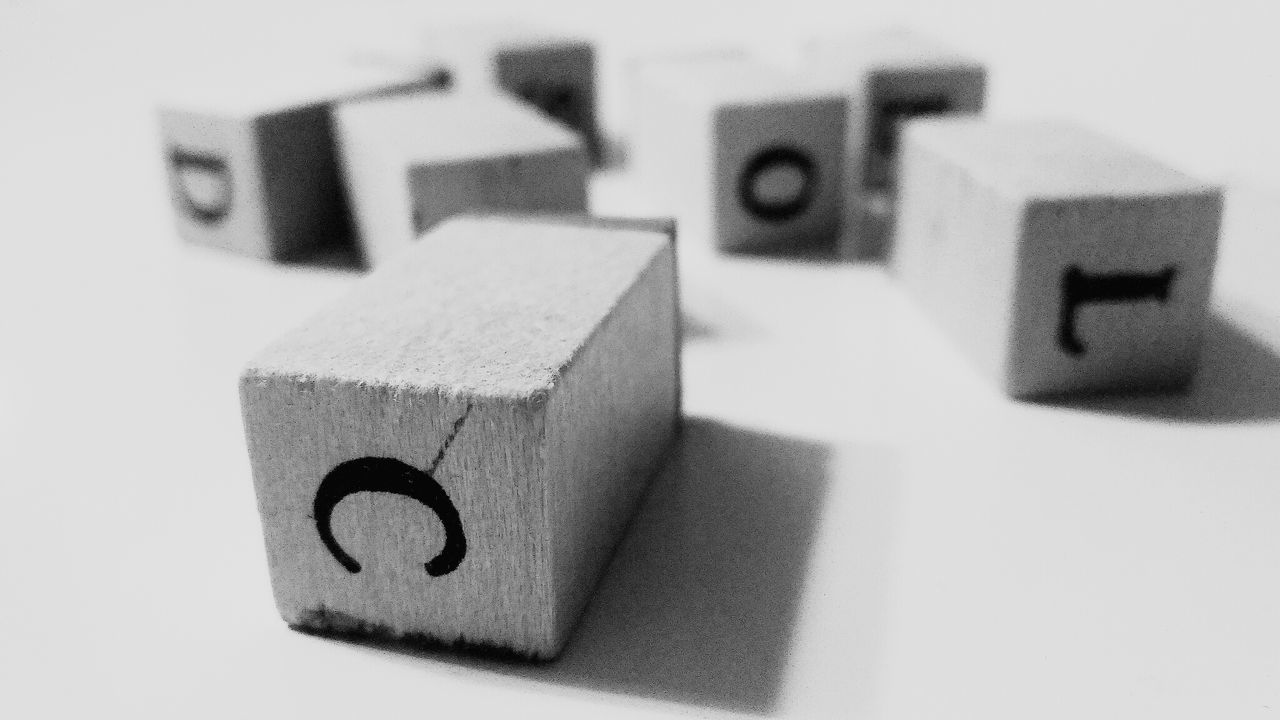 Close-up of blocks with letters on table