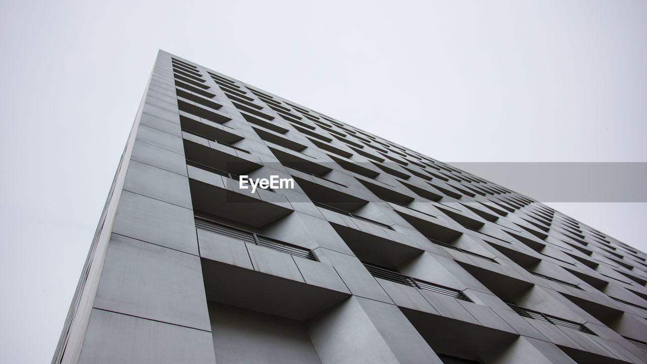 Low angle view of office building against sky