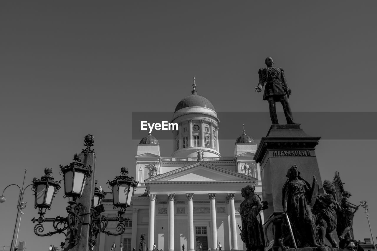 architecture, built structure, building exterior, sky, black and white, travel destinations, landmark, statue, sculpture, dome, the past, history, monochrome, representation, nature, low angle view, clear sky, monochrome photography, human representation, travel, building, no people, city, tourism, religion, government, place of worship, architectural column, belief, outdoors