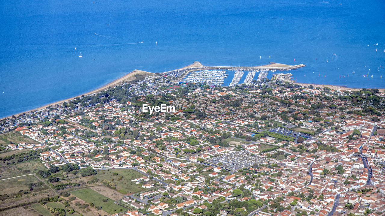 High angle view of buildings by sea