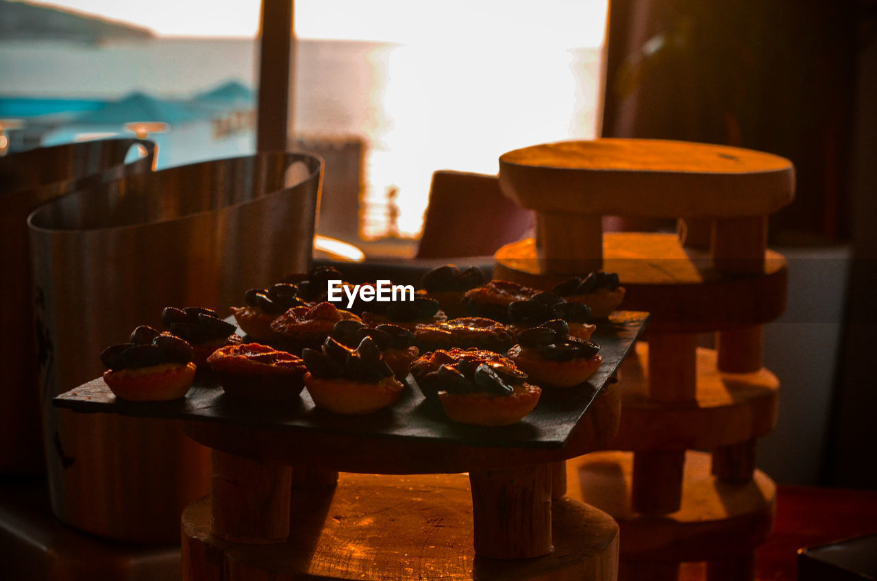 CLOSE-UP OF ICE CREAM ON WOODEN TABLE