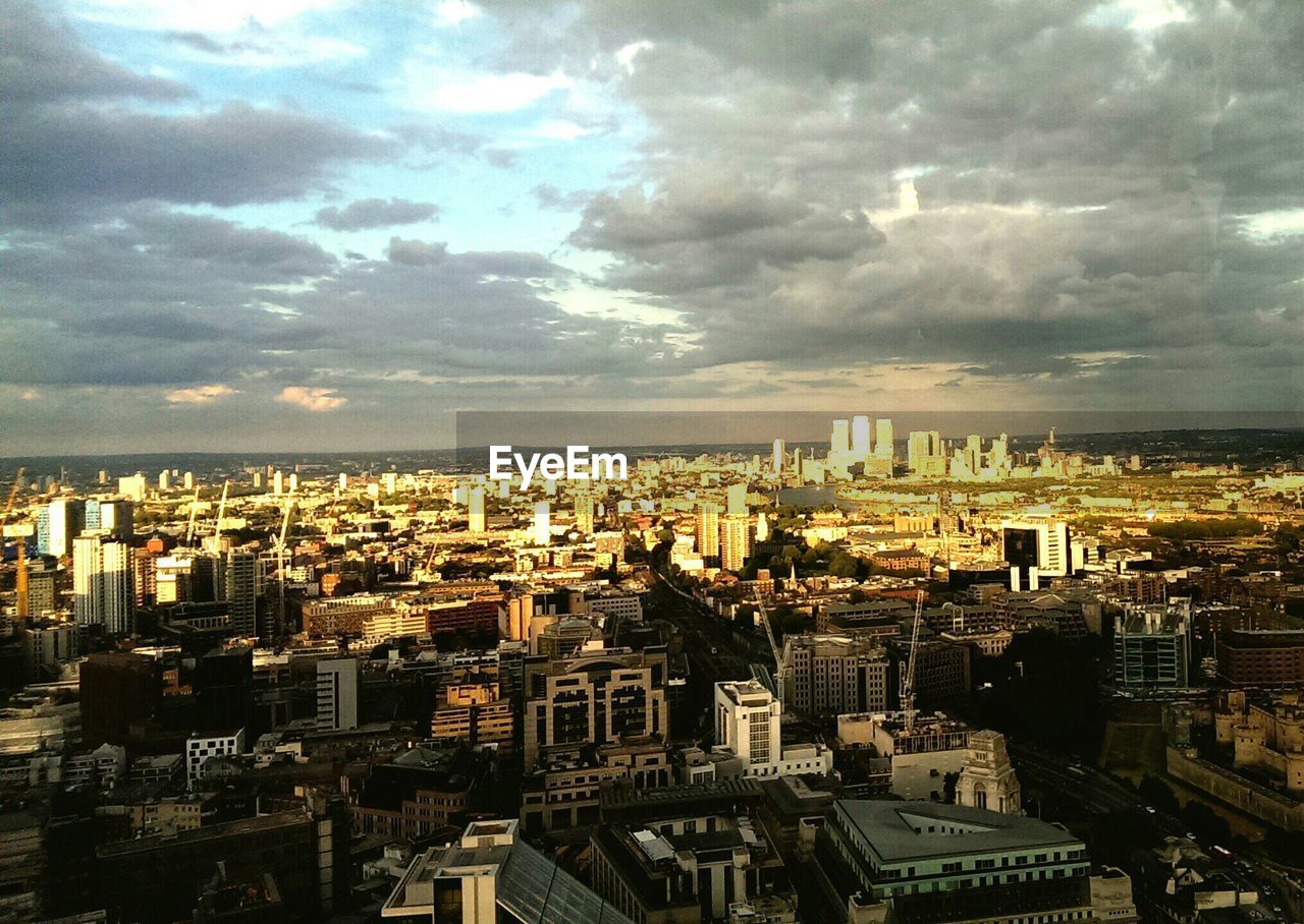 VIEW OF CITYSCAPE AGAINST CLOUDY SKY