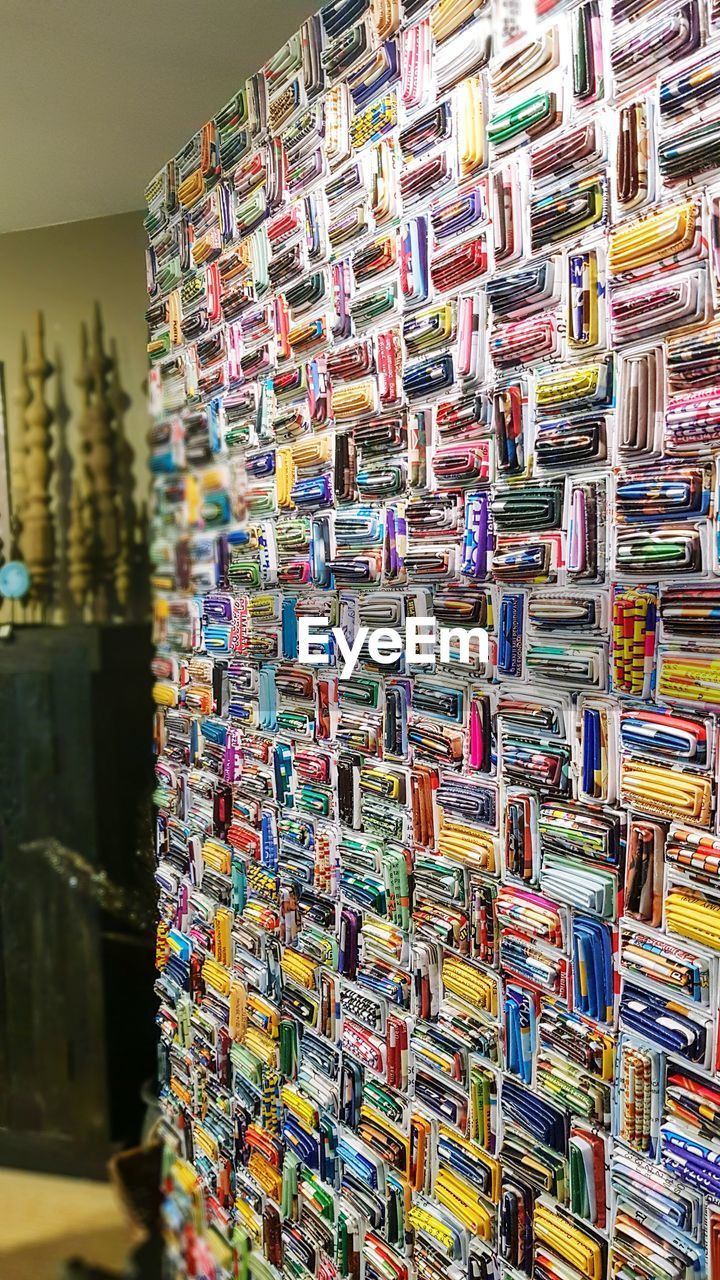 CLOSE-UP OF MULTI COLORED CLOTHES HANGING FOR SALE