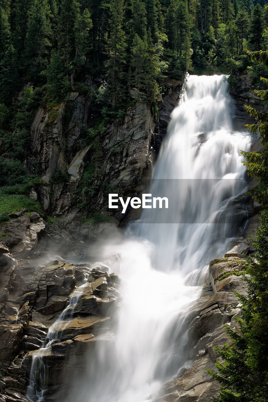 SCENIC VIEW OF WATERFALL AGAINST TREES